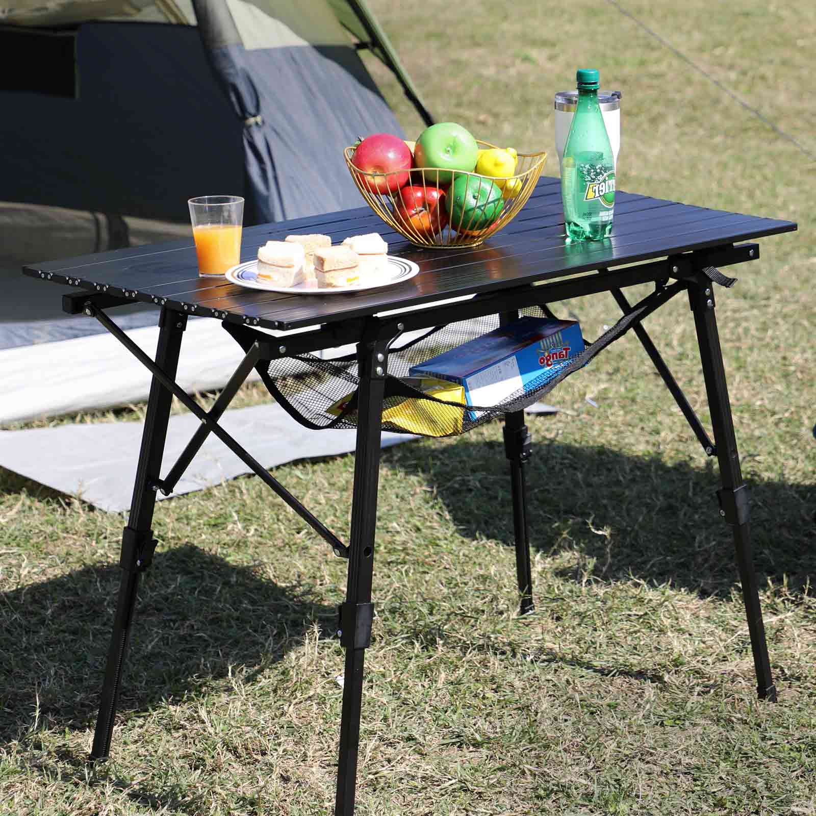 Portal Outdoors Camping table with food and drinks on a grassy area
